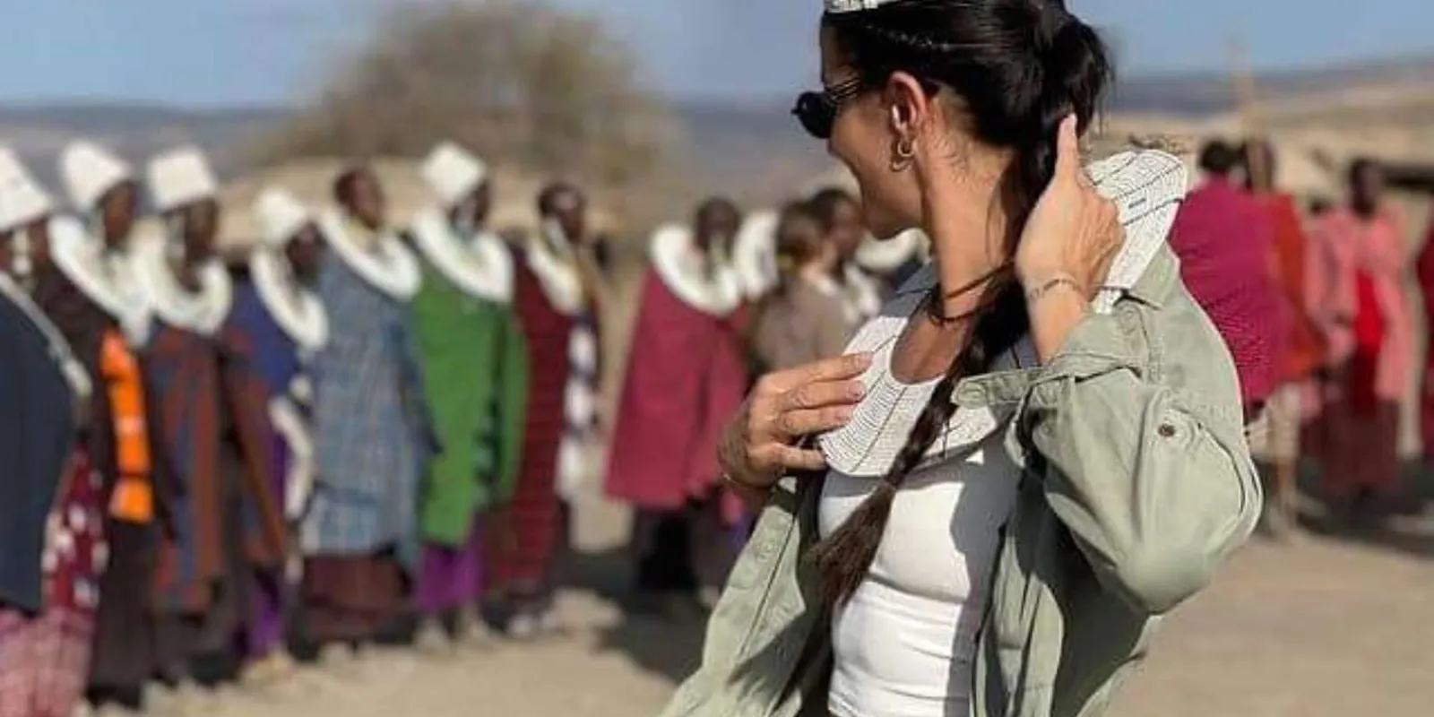 Traveller being welcomed by Maasai women in beaded collars at a village visit
