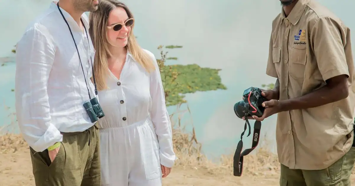 Travellers photographing wildlife with their guide on a Mikumi day safari from Zanzibar